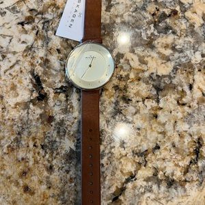 Skagen Denmark stainless steel and leather round face watch.